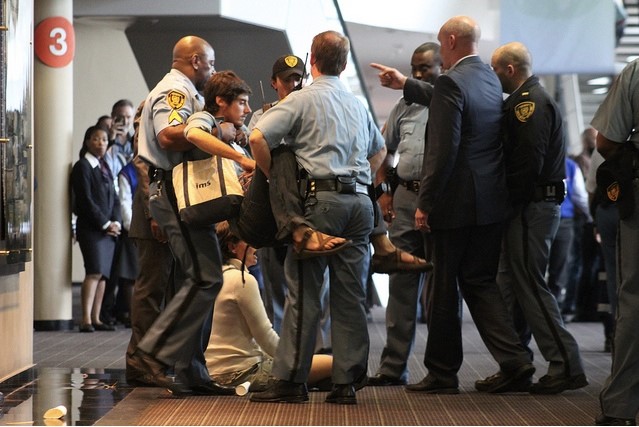 GJEP is removed by UN security during sit-in occupation. Photo: Ben Powless